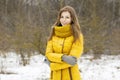 Pretty woman in a yellow knit scarf. Outdoor portrait in the par