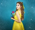 Pretty woman in the yellow long dress closeup with red rose in her hands. Beauty and the beast cosplay art processing Royalty Free Stock Photo