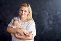 Pretty woman holding a newborn baby girl in her arms. Happy moth Royalty Free Stock Photo