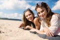 Pretty women lying on beach smiling Royalty Free Stock Photo