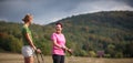 Pretty, women nordic walking on a forest path, taking in t