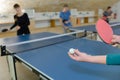 Pretty woman playing ping-pong with friends Royalty Free Stock Photo