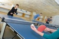 Pretty woman playing ping-pong with friends Royalty Free Stock Photo