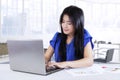 Pretty worker uses laptop in workplace Royalty Free Stock Photo