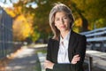 Pretty worried woman at the park. Serious Middle Aged woman