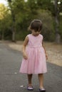 Pretty 3 1/2 year old Asian-Caucasian girl standing on grass