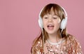 Pretty 6 or 7 years old little girl singing and dancing with headphones Royalty Free Stock Photo