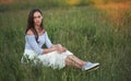 Pretty 30 years old woman is sitting on a grass Royalty Free Stock Photo