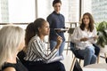 Pretty young African American employee speaking on corporate meeting Royalty Free Stock Photo