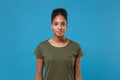 Pretty young african american woman girl in casual t-shirt posing isolated on bright blue background studio portrait Royalty Free Stock Photo