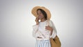 Pretty young african american woman in a straw hat talking on he Royalty Free Stock Photo