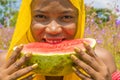 pretty young african lady enjoying a delicious slice of watermelon fruit outside Royalty Free Stock Photo