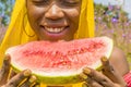 pretty young african lady enjoying a delicious slice of watermelon fruit outside Royalty Free Stock Photo