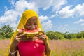 pretty young african lady enjoying a delicious slice of watermelon fruit outside Royalty Free Stock Photo