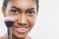 Pretty young african woman is doing facial make-up Royalty Free Stock Photo