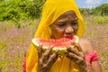 pretty young african woman eating watermelon outside Royalty Free Stock Photo