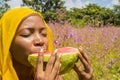 pretty young african woman eating watermelon outside Royalty Free Stock Photo