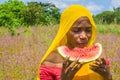 pretty young african woman eating watermelon outside Royalty Free Stock Photo