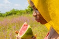 pretty young african woman eating watermelon outside Royalty Free Stock Photo