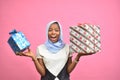 pretty young african woman holding two gift boxes feeling excited and happy Royalty Free Stock Photo