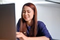 Pretty young Asian female college student using laptop computer Royalty Free Stock Photo