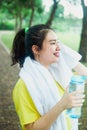 Pretty young asian girl taking a break in the park in the morning. Fresh and healthy lifestyle for teenager