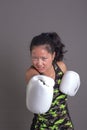 Pretty young asian woman with boxing gloves Royalty Free Stock Photo