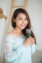 Pretty young asian woman drinking green fresh vegetable juice or Royalty Free Stock Photo