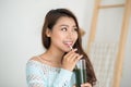 Pretty young asian woman drinking green fresh vegetable juice or Royalty Free Stock Photo