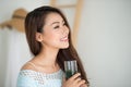 Pretty young asian woman drinking green fresh vegetable juice or Royalty Free Stock Photo