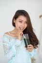 Pretty young asian woman drinking green fresh vegetable juice or Royalty Free Stock Photo