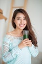 Pretty young asian woman drinking green fresh vegetable juice or Royalty Free Stock Photo