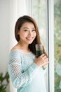 Pretty young asian woman drinking green fresh vegetable juice or Royalty Free Stock Photo