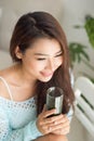 Pretty young asian woman holding green fresh vegetable juice or Royalty Free Stock Photo