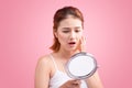 Pretty young asian woman holding a mirror, touch and worrying ab Royalty Free Stock Photo