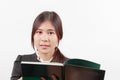 Pretty young Asian woman reading a book with considerate and thoughtful posture. Royalty Free Stock Photo