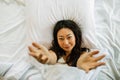 Young Asian Woman Sleeping In Bed with white sheets. Royalty Free Stock Photo