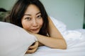 Young Asian Woman Sleeping In Bed with white sheets. Royalty Free Stock Photo
