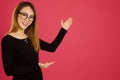 Pretty young asian woman in the studio pointing with both hands Royalty Free Stock Photo