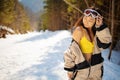 Pretty young asian woman in ski clothing having winter rest outdoor. Royalty Free Stock Photo