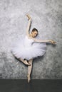 Pretty young ballerina dancer dancing classical ballet against rustic wall Royalty Free Stock Photo