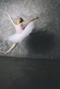 Pretty young ballerina dancer dancing classical ballet against rustic wall Royalty Free Stock Photo