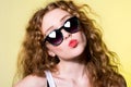 Pretty young beautiful girl in sunglasses makes lips kiss Royalty Free Stock Photo