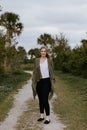 Pretty Young Beauty Woman Model with Gorgeous Long Blond Hair Blowing in the Wind Smiling for Portrait Shots Outside at the Park Royalty Free Stock Photo