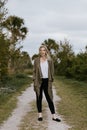 Pretty Young Beauty Woman Model with Gorgeous Long Blond Hair Blowing in the Wind Smiling for Portrait Shots Outside at the Park Royalty Free Stock Photo