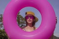 Pretty young bikni woman in the middle of pink inflatable ring Royalty Free Stock Photo