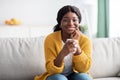 Cheerful pretty black woman drinking coffee at home Royalty Free Stock Photo