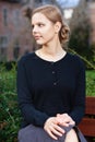 Pretty young blond woman sitting on bench Royalty Free Stock Photo