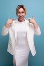 pretty young blonde business woman in a jacket and dress shows her smile Royalty Free Stock Photo