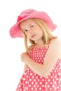 Pretty, young blonde girl wearing pink floppy hat and a polka dot dress. Isolated on white studio background Royalty Free Stock Photo